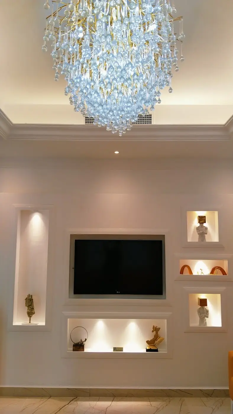 Crystal chandelier and lit wall niches in the lounge