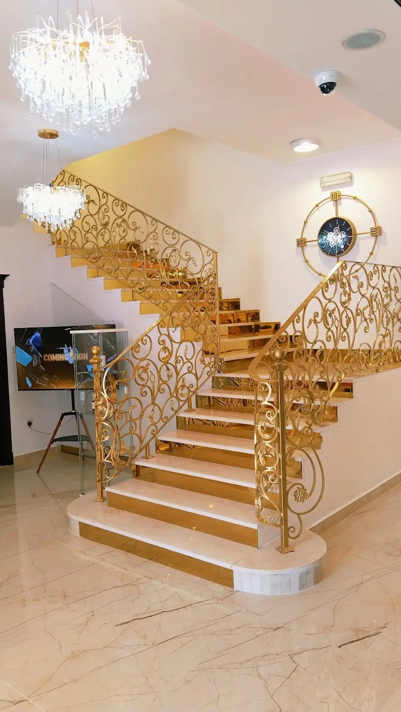 The gold staircase and marble hall inside TopNotch Polyclinic